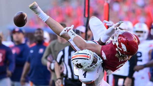 Razorbacks wide receiver Isaac TeSlaa gets pass jarred loose by Auburn's DJ James